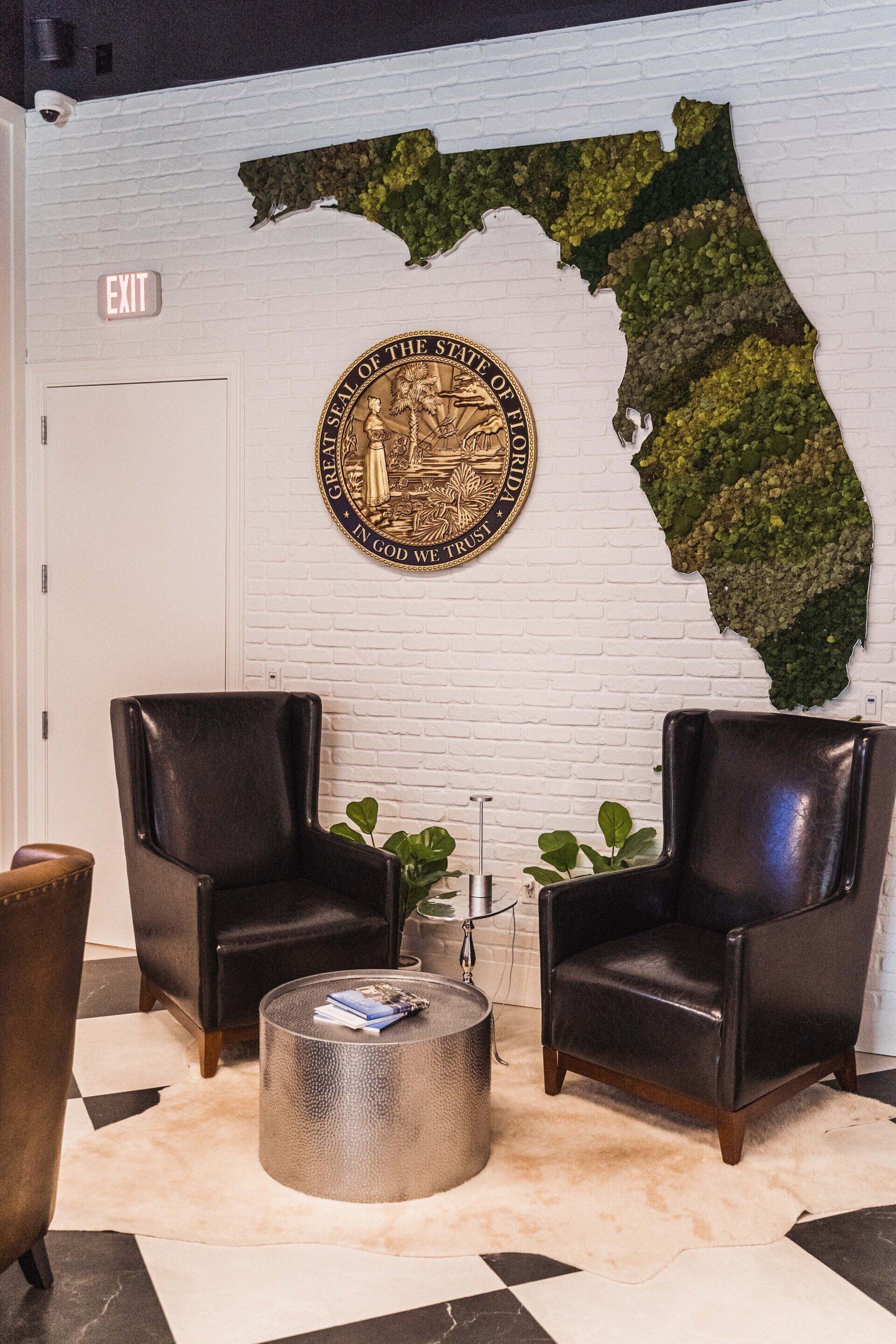 There is a map of florida on the wall above the chairs.