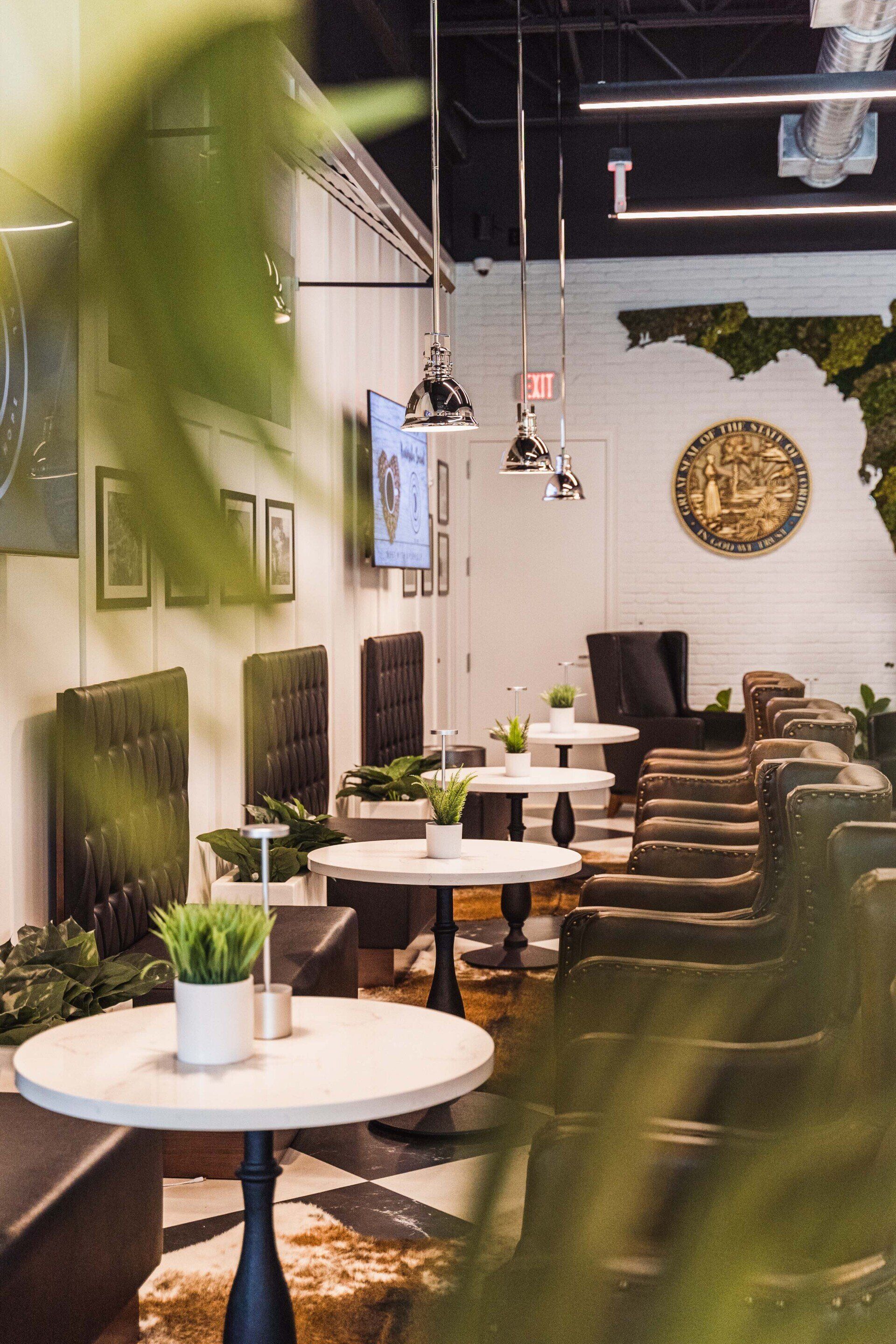 A restaurant with tables and chairs and a clock on the wall.