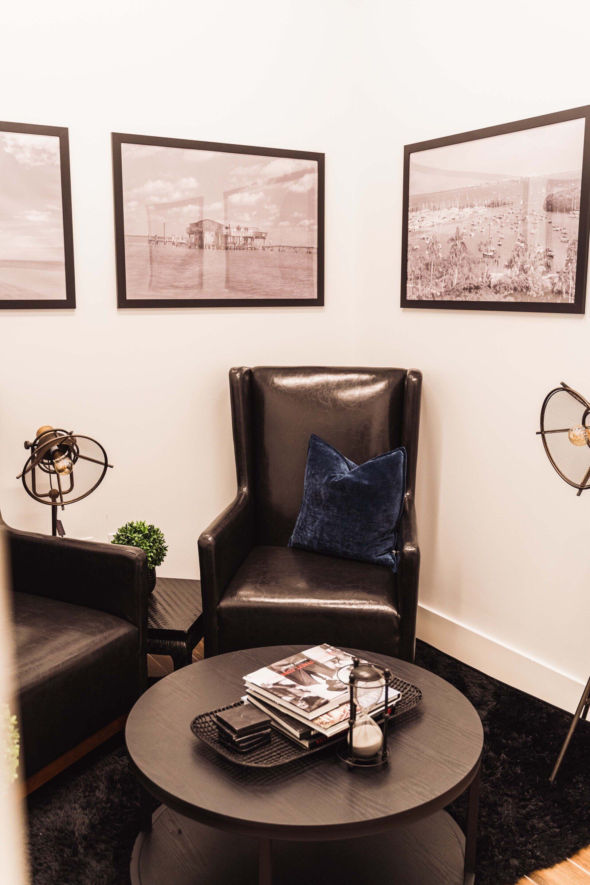 A living room with two chairs and a round table.