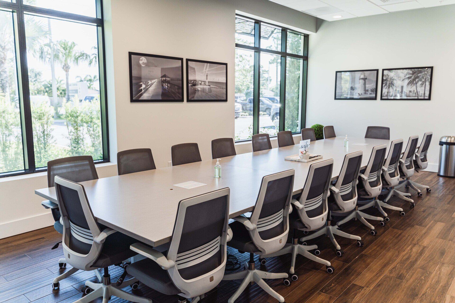 A conference room with a long table and chairs.