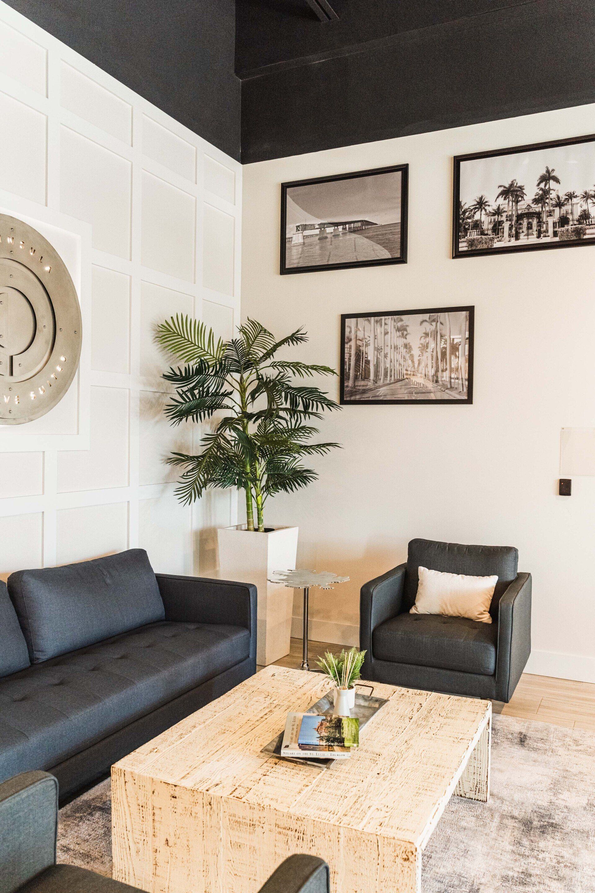 A living room with a couch , chairs , and a coffee table.
