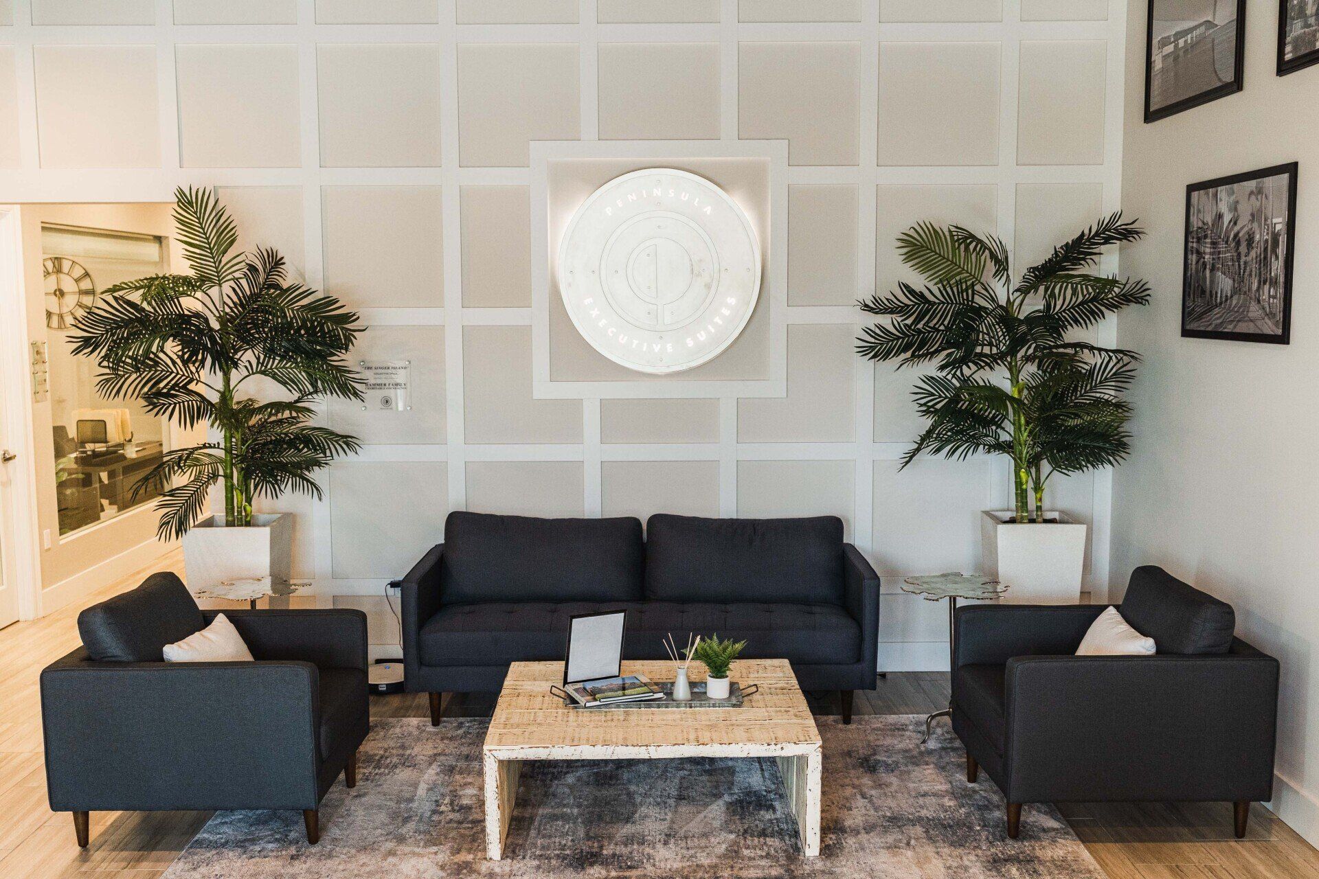 A living room with a couch , chairs , and a coffee table.