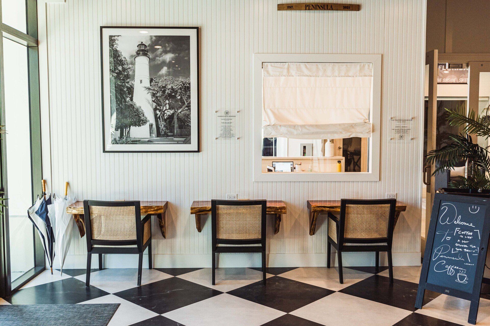 There is a picture of a lighthouse on the wall above the chairs.