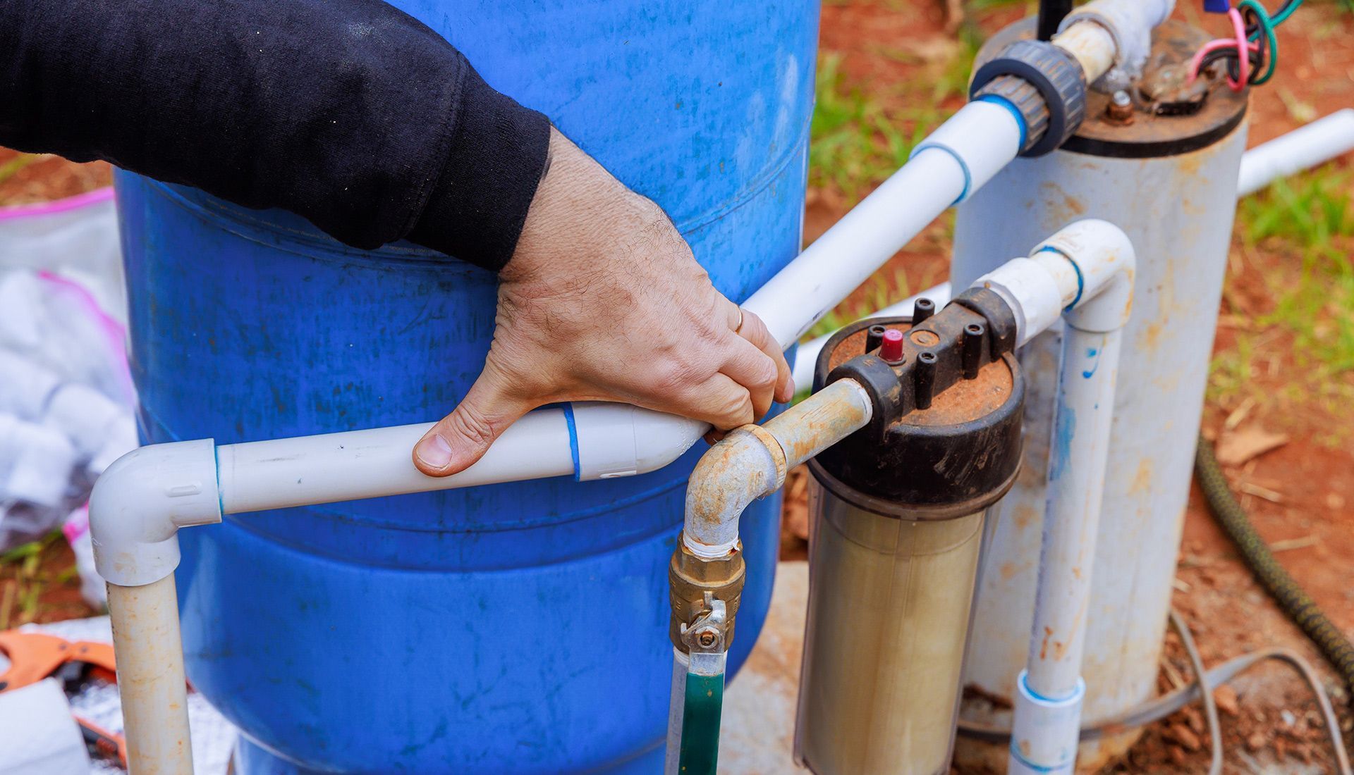 A person is working on a water pump.