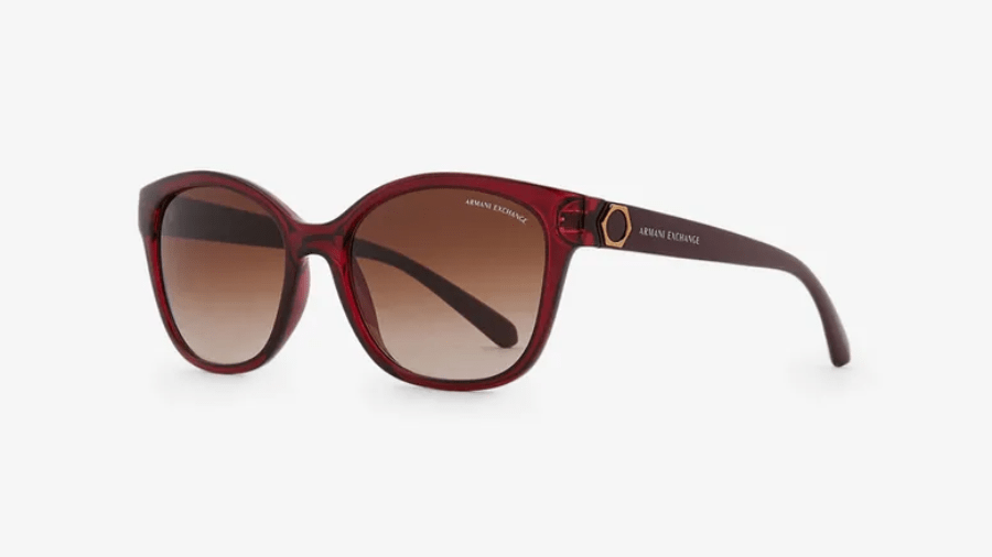 A pair of red sunglasses with brown lenses on a white background.