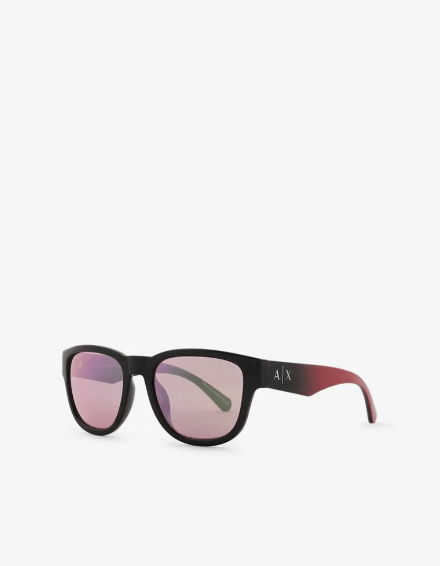 A pair of sunglasses with a black frame and pink lenses on a white background.