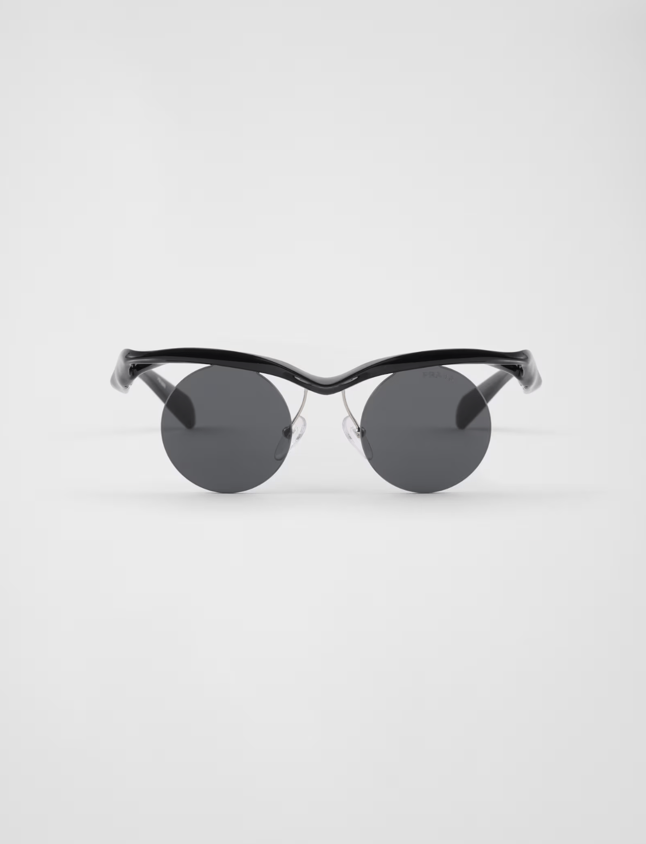 A pair of black round sunglasses on a white background.