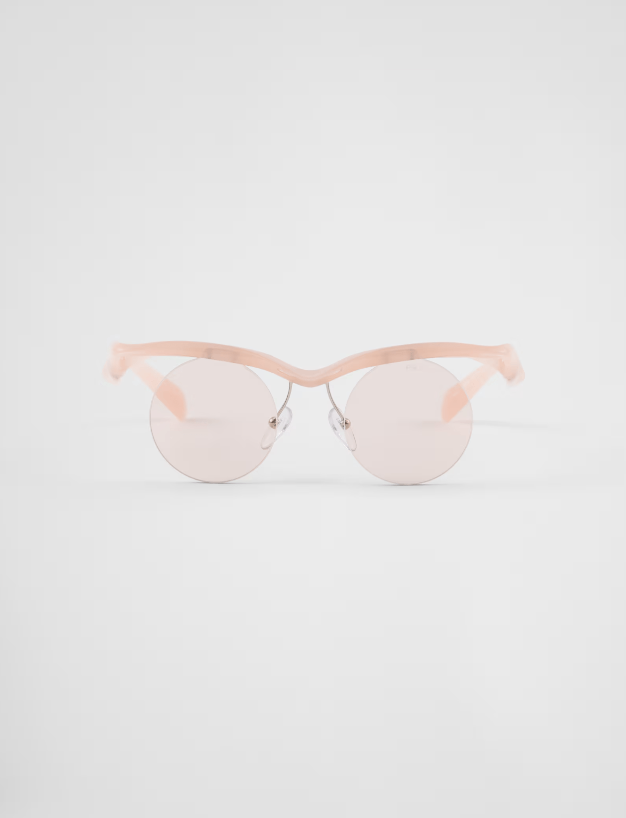 A pair of pink sunglasses on a white background.