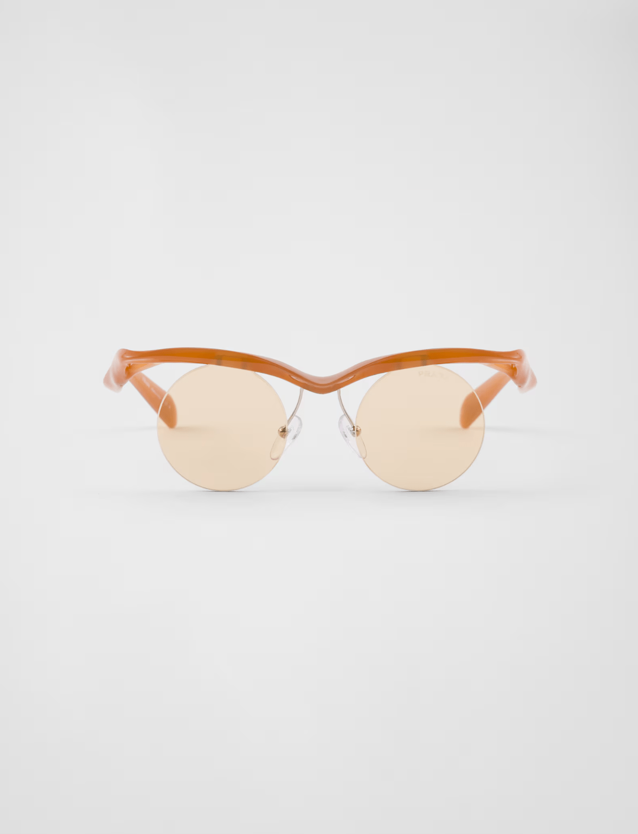 A pair of sunglasses are sitting on a white surface.