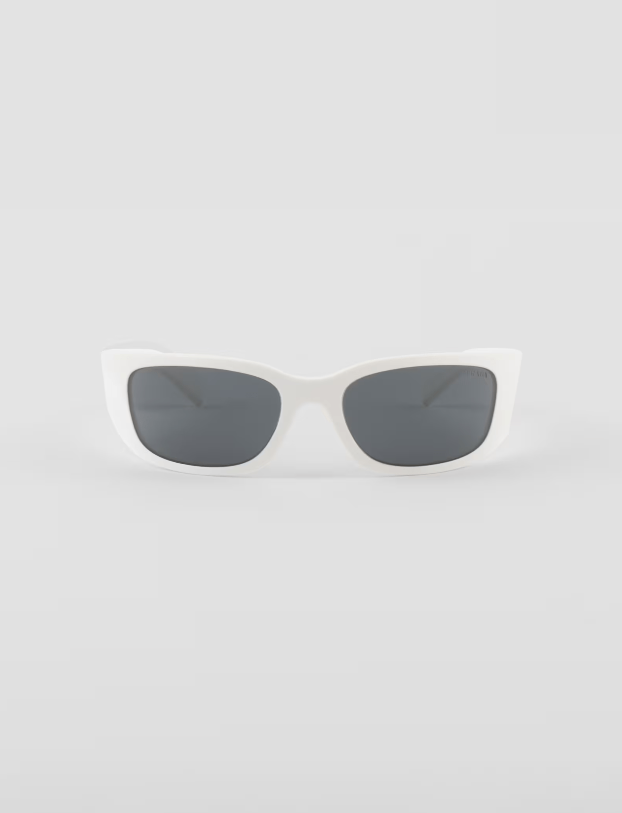 A pair of white sunglasses with black lenses on a white background.