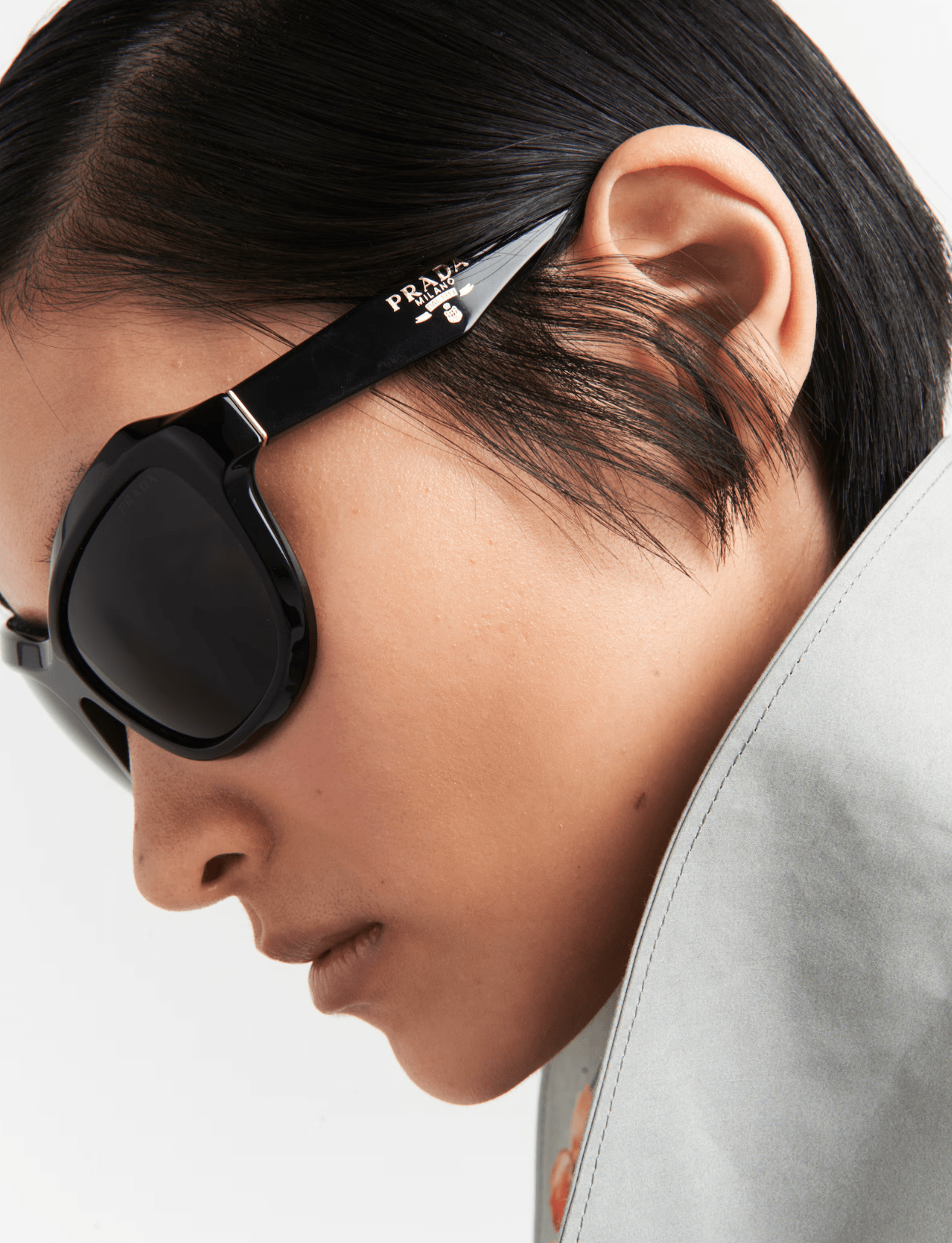 A close up of a woman wearing prada sunglasses