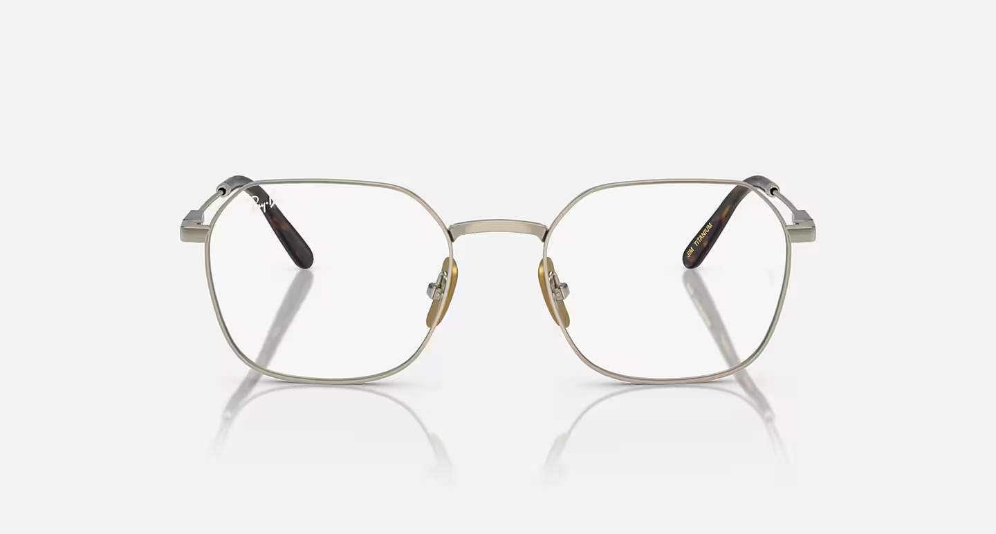 A pair of glasses are sitting on a white surface.