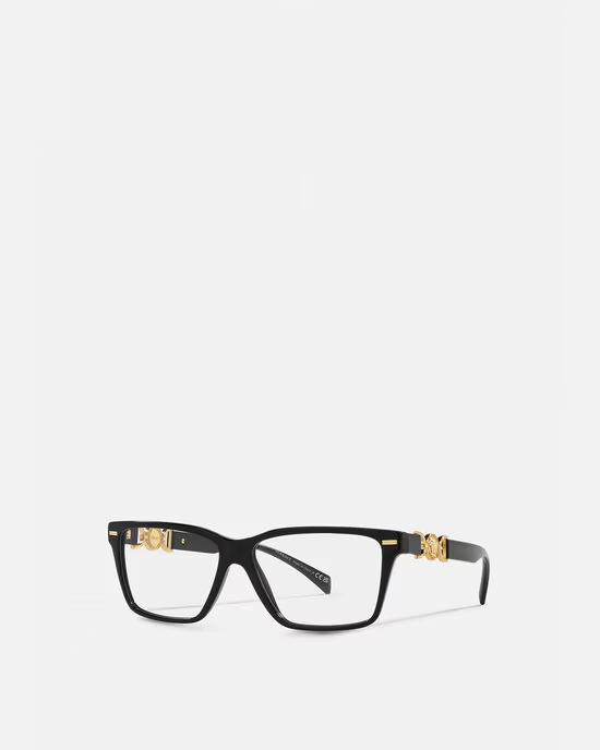 A pair of black glasses with gold trim on a white background.