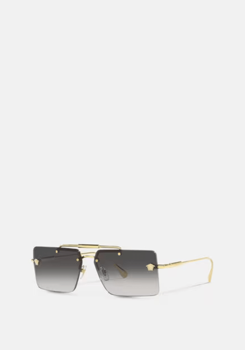 A pair of square sunglasses with a gold frame on a white background.
