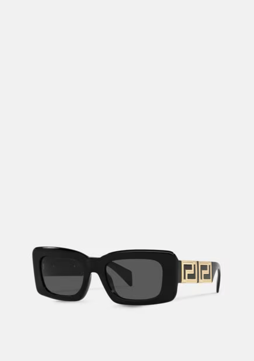 A pair of black sunglasses with a gold buckle on a white background.