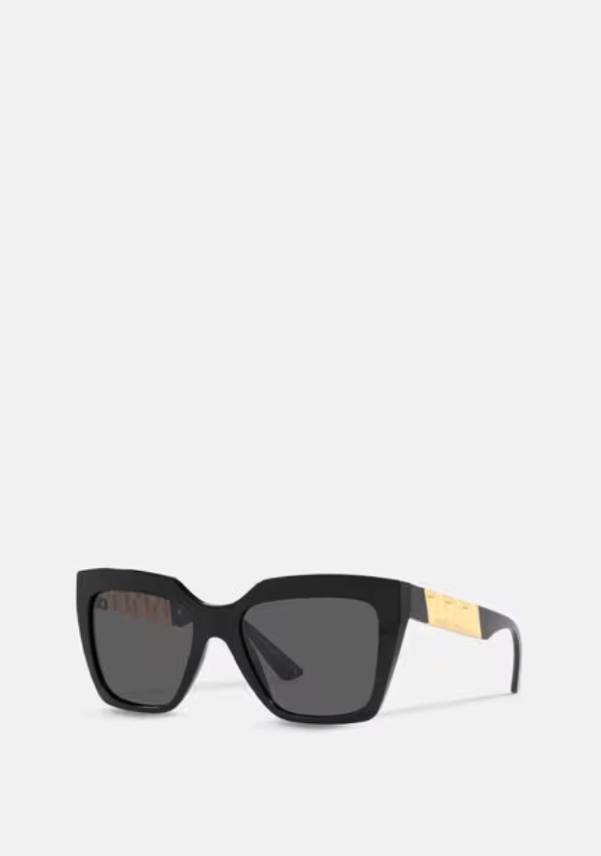 A pair of black sunglasses with a gold trim on a white background.