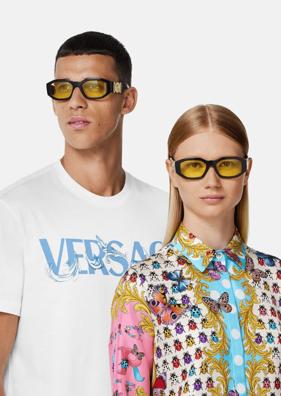 A man and a woman wearing sunglasses are standing next to each other.