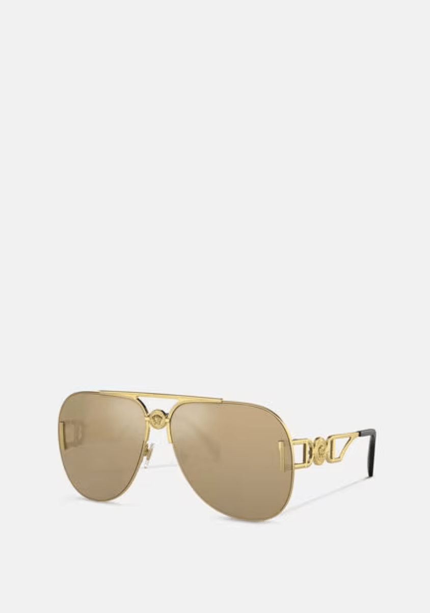 A pair of gold aviator sunglasses on a white background.