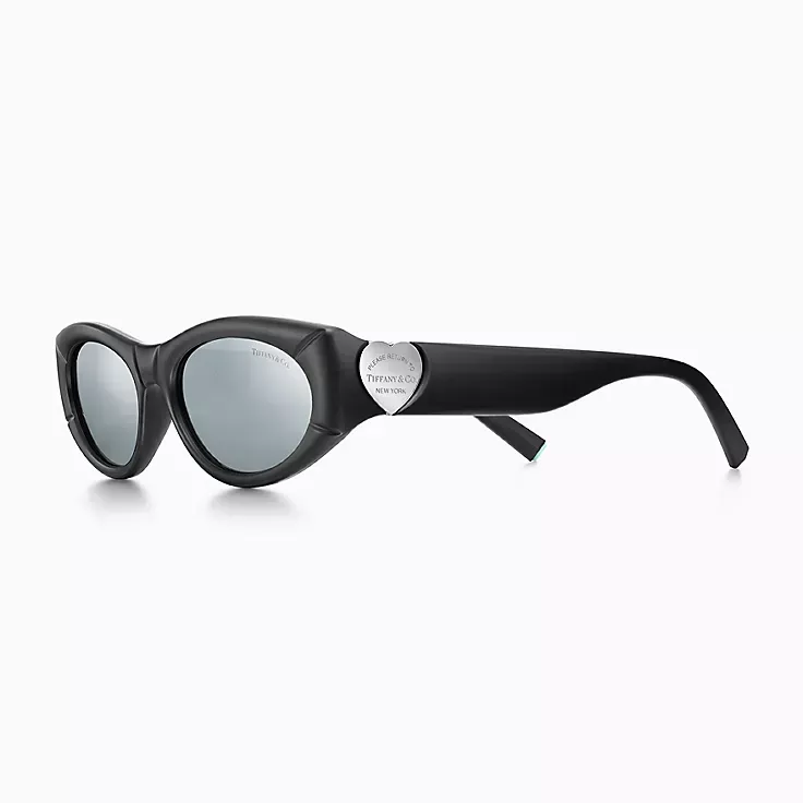 A pair of sunglasses with a heart on the side on a white background.