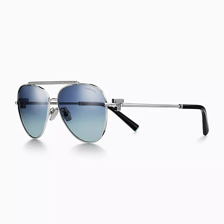 A pair of aviator sunglasses with blue lenses on a white background.