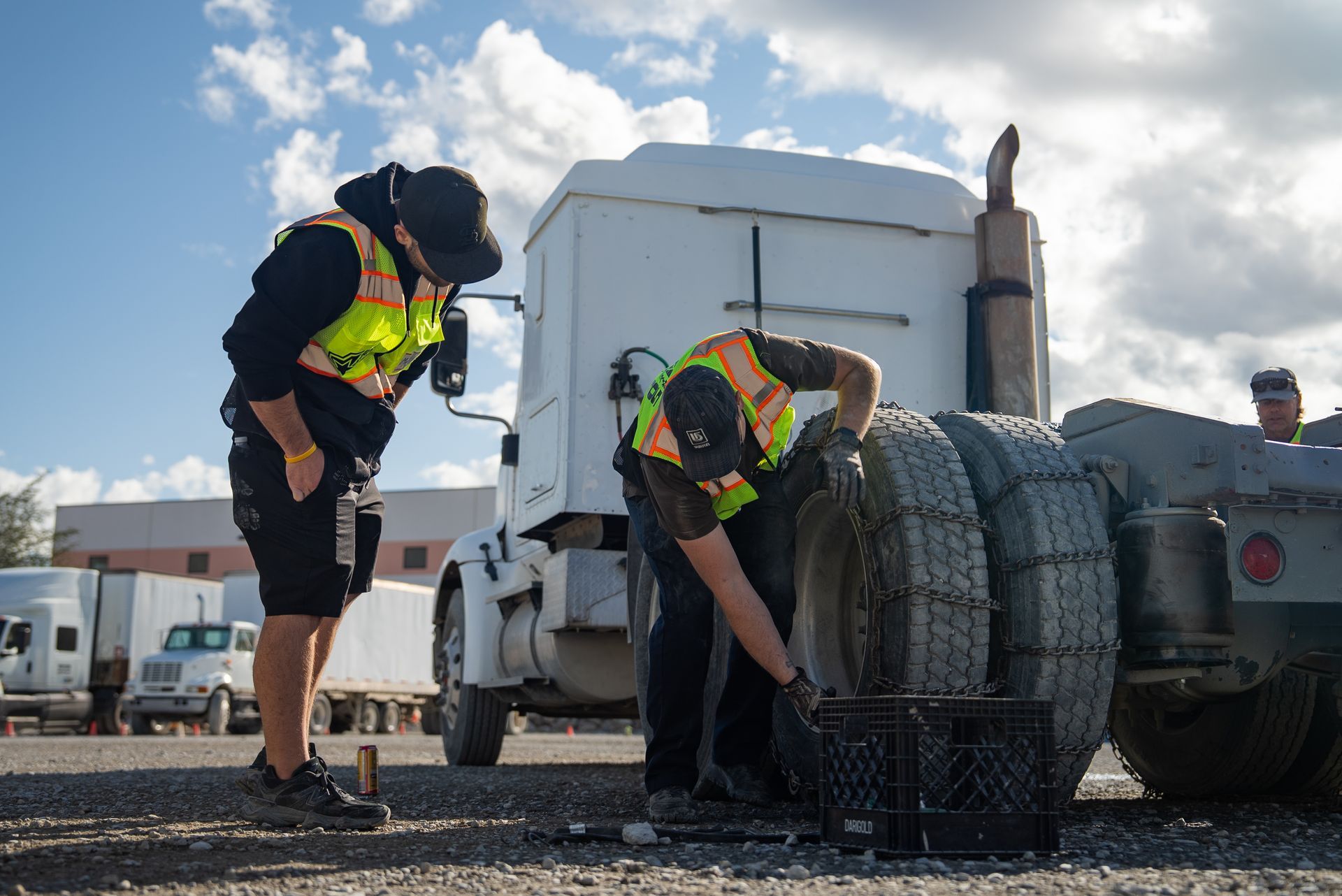 a group of cdl students standing in a circle getting instructor feedback on the CDL refresher course