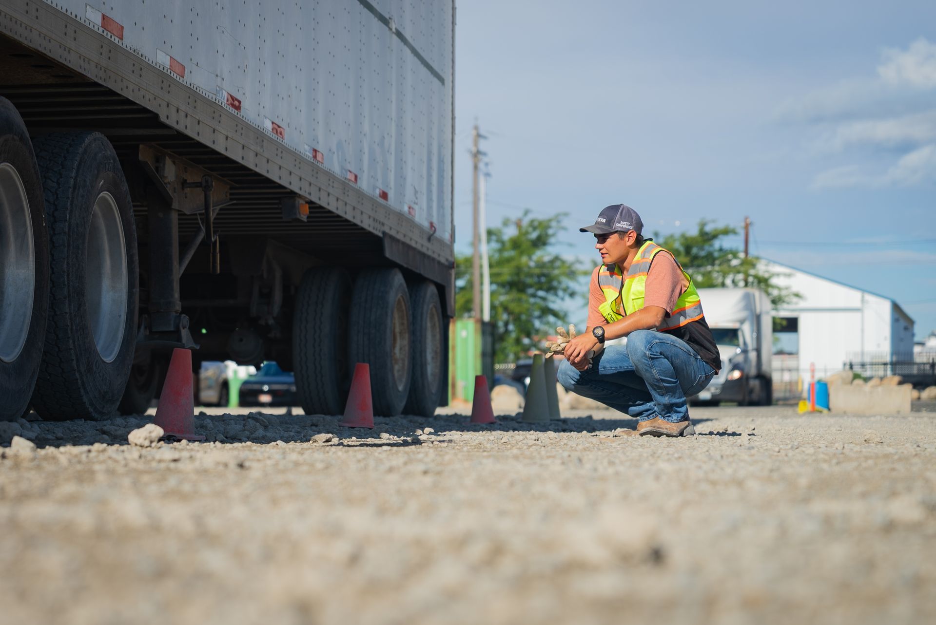 a cdl student standing in front of white semi truck taking a cdl company training course