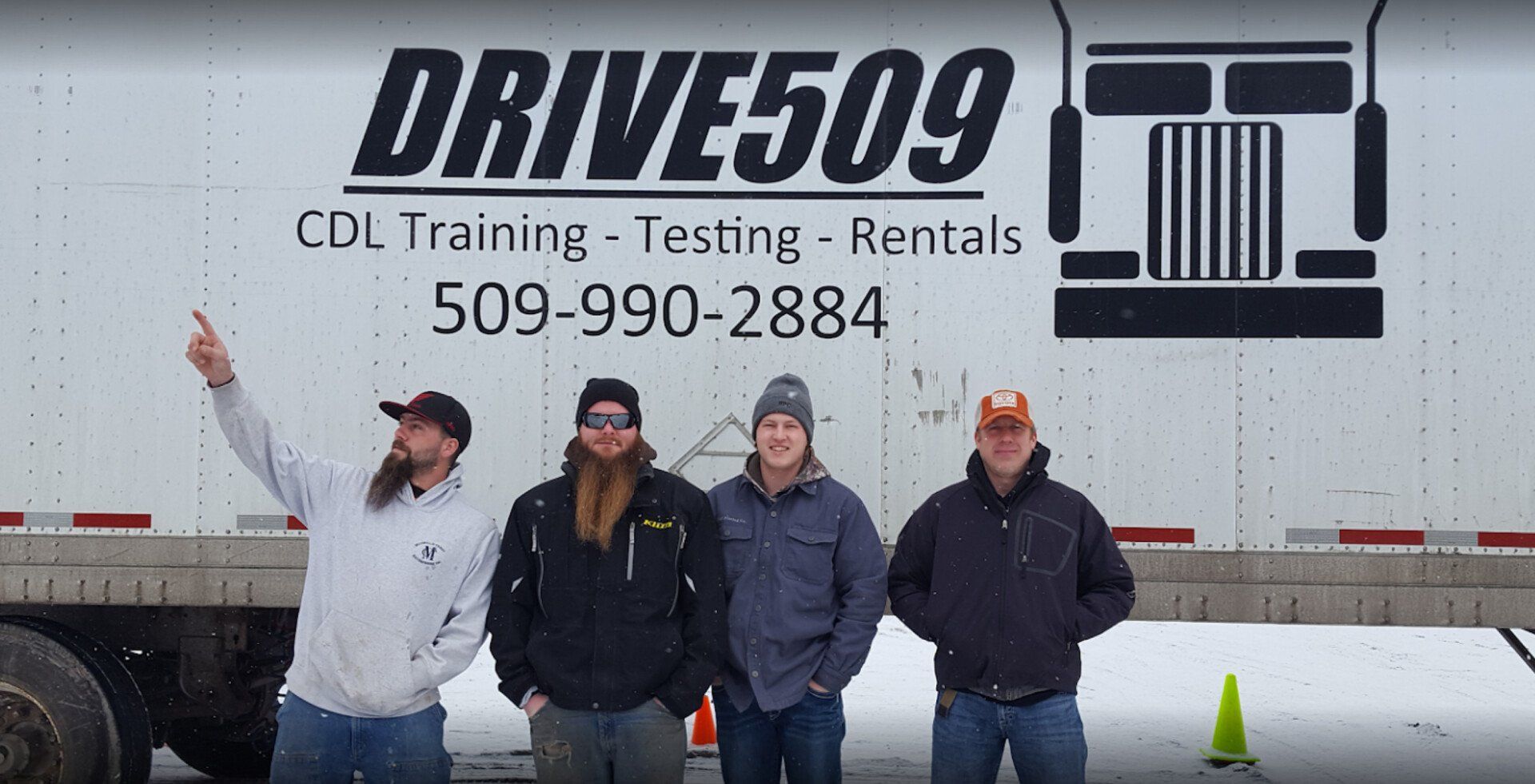 drive509 team standing in front of semi-truck getting ready for a cdl school session