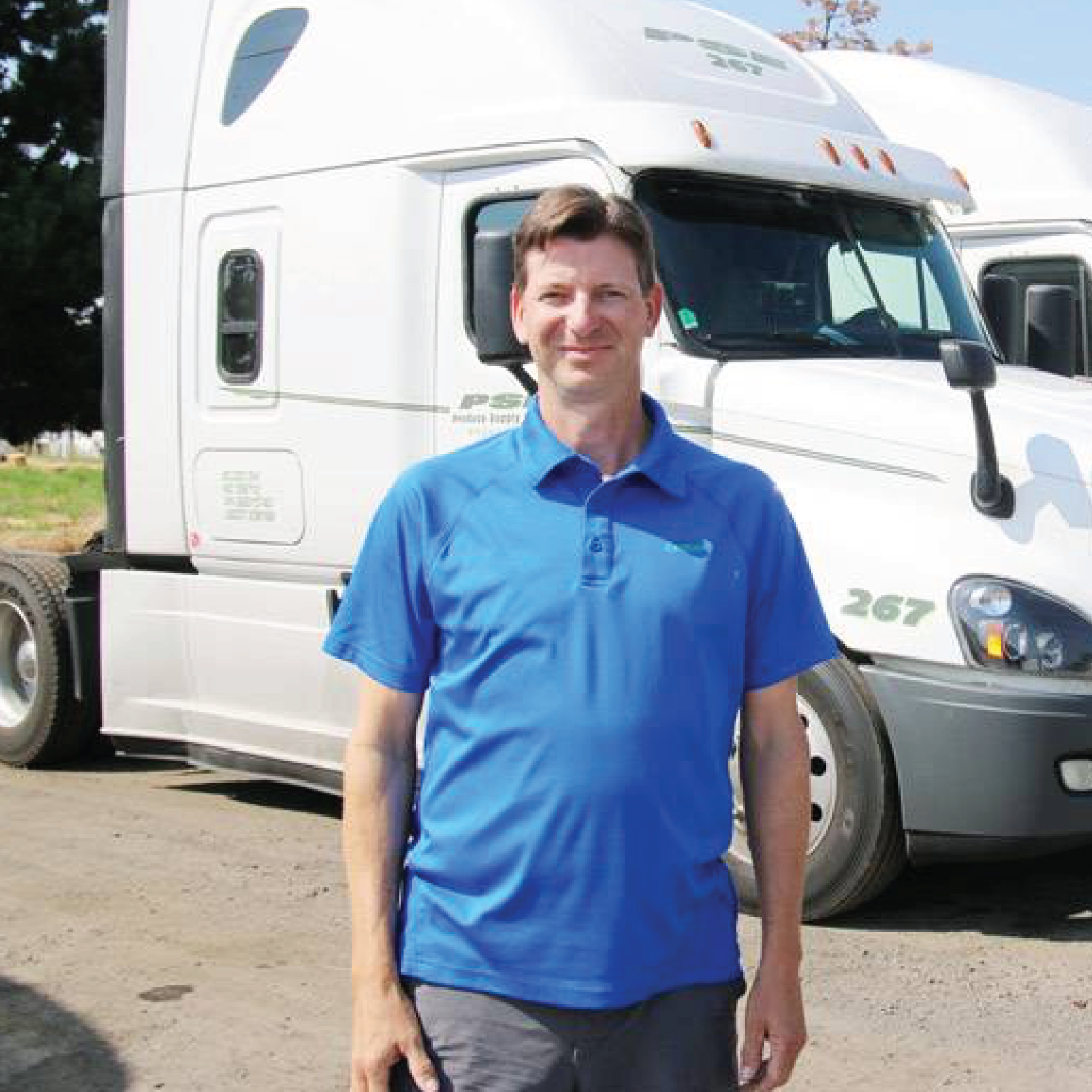 a cdl student standing in front of white semi truck taking a cdl company training course