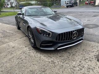 Gray Mercedes-AMG GT sports car parked on a concrete surface.