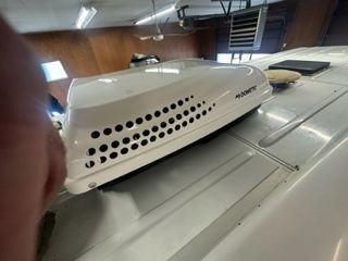White RV rooftop with a Dometic air conditioner.