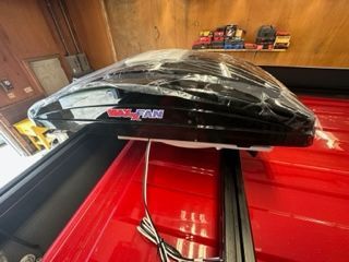 Black truck bed cargo box, red truck bed, with wiring, inside garage.