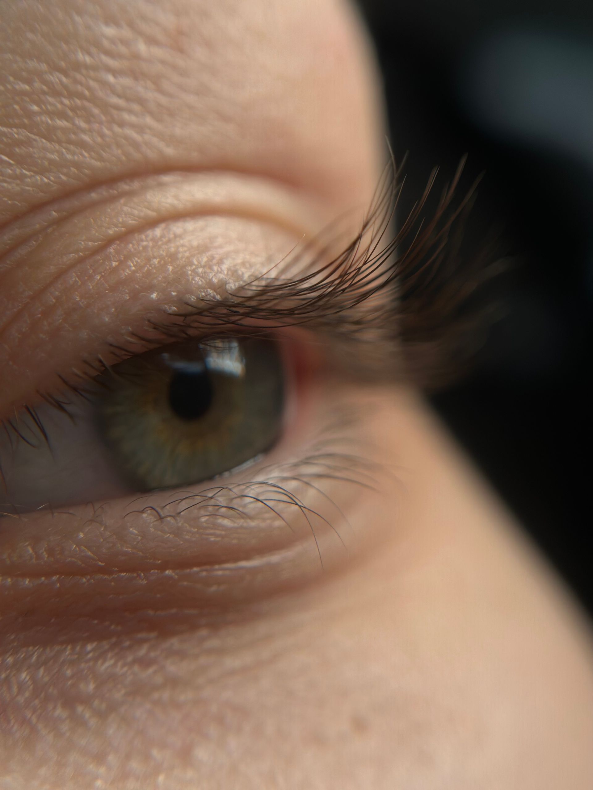 A close up of a woman 's eye with long eyelashes