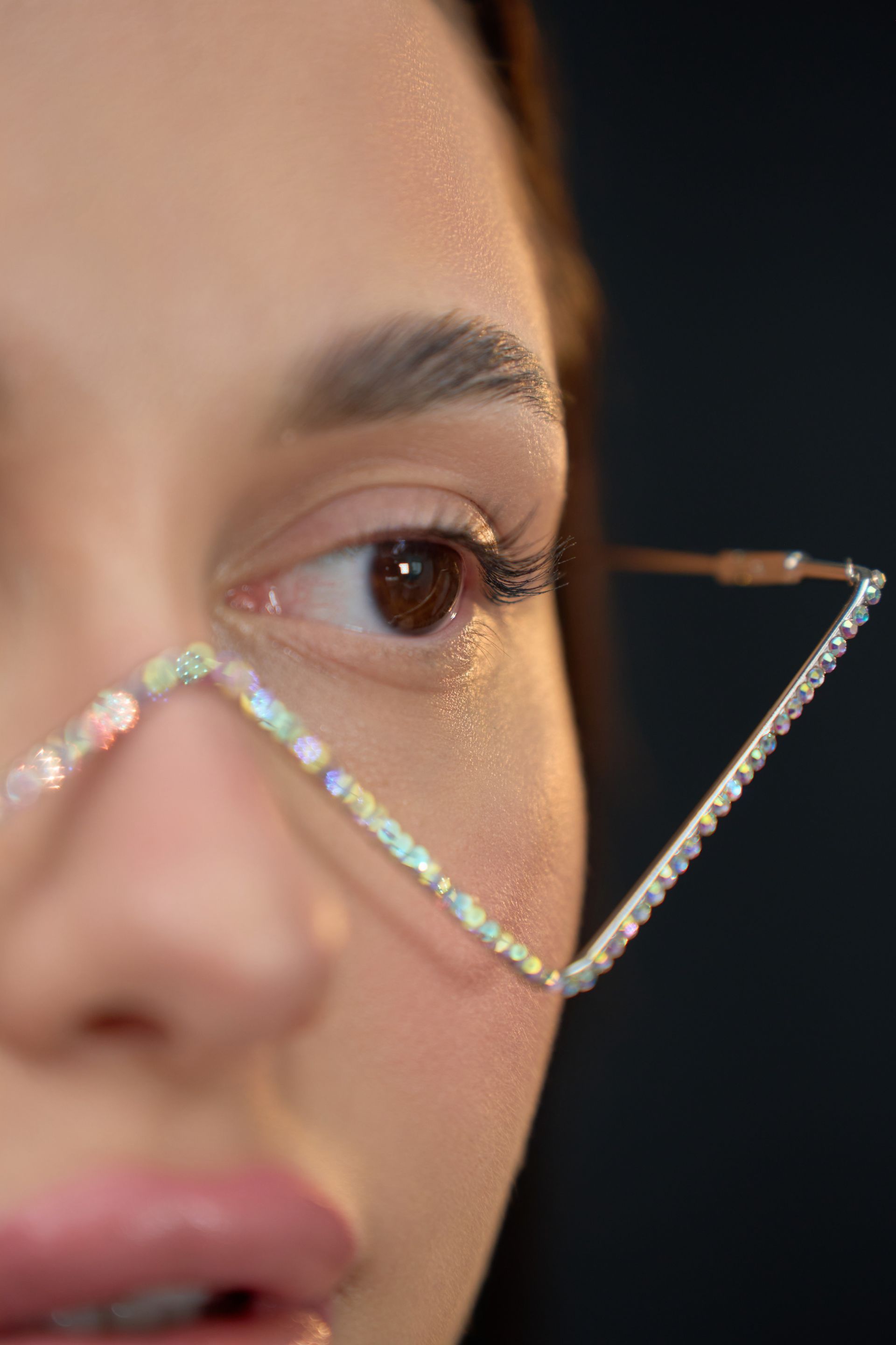 A close up of a woman wearing glasses on her face.