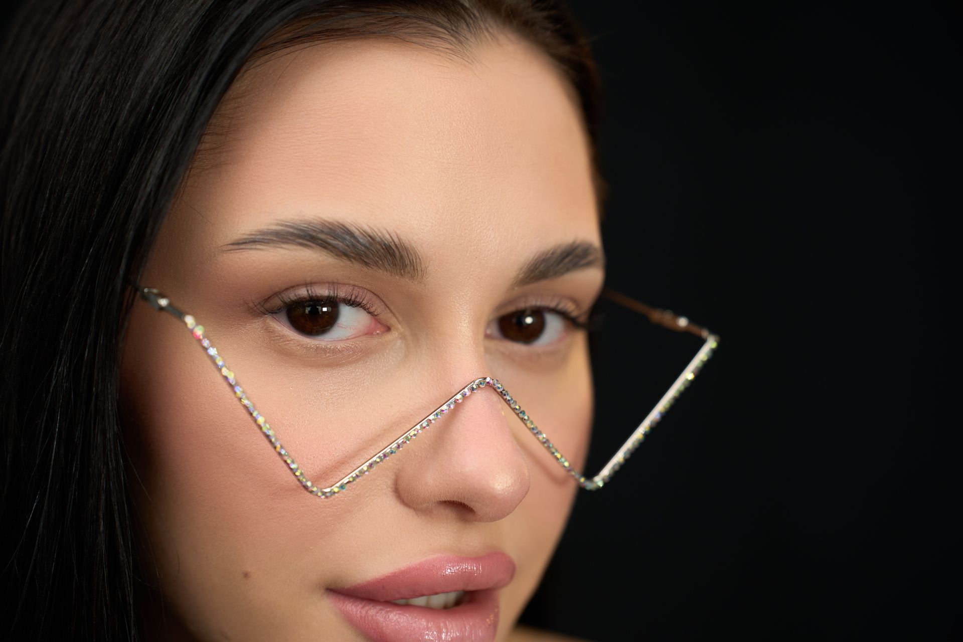 A close up of a woman wearing glasses on her face.