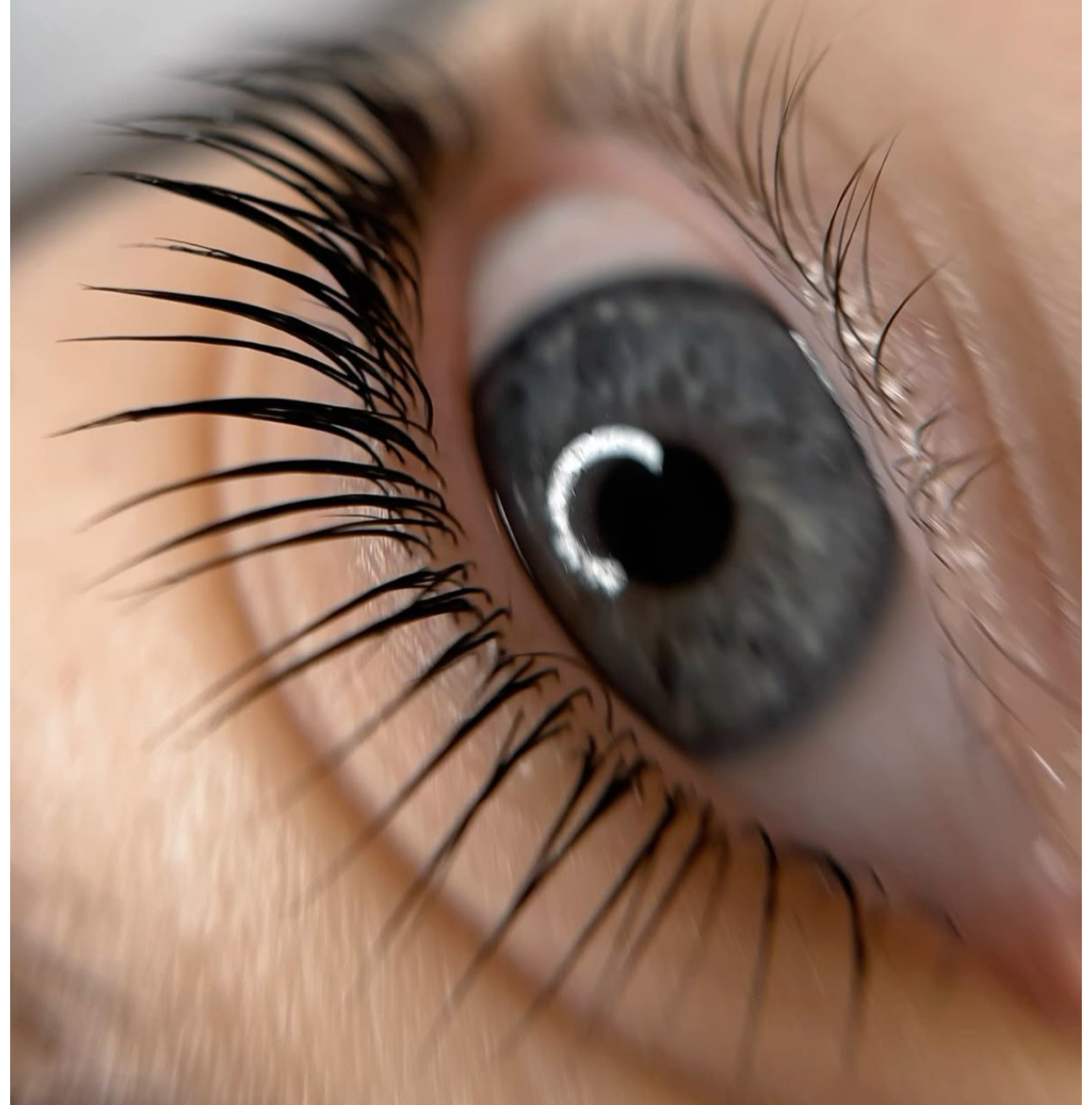 A close up of a woman 's eye with long eyelashes