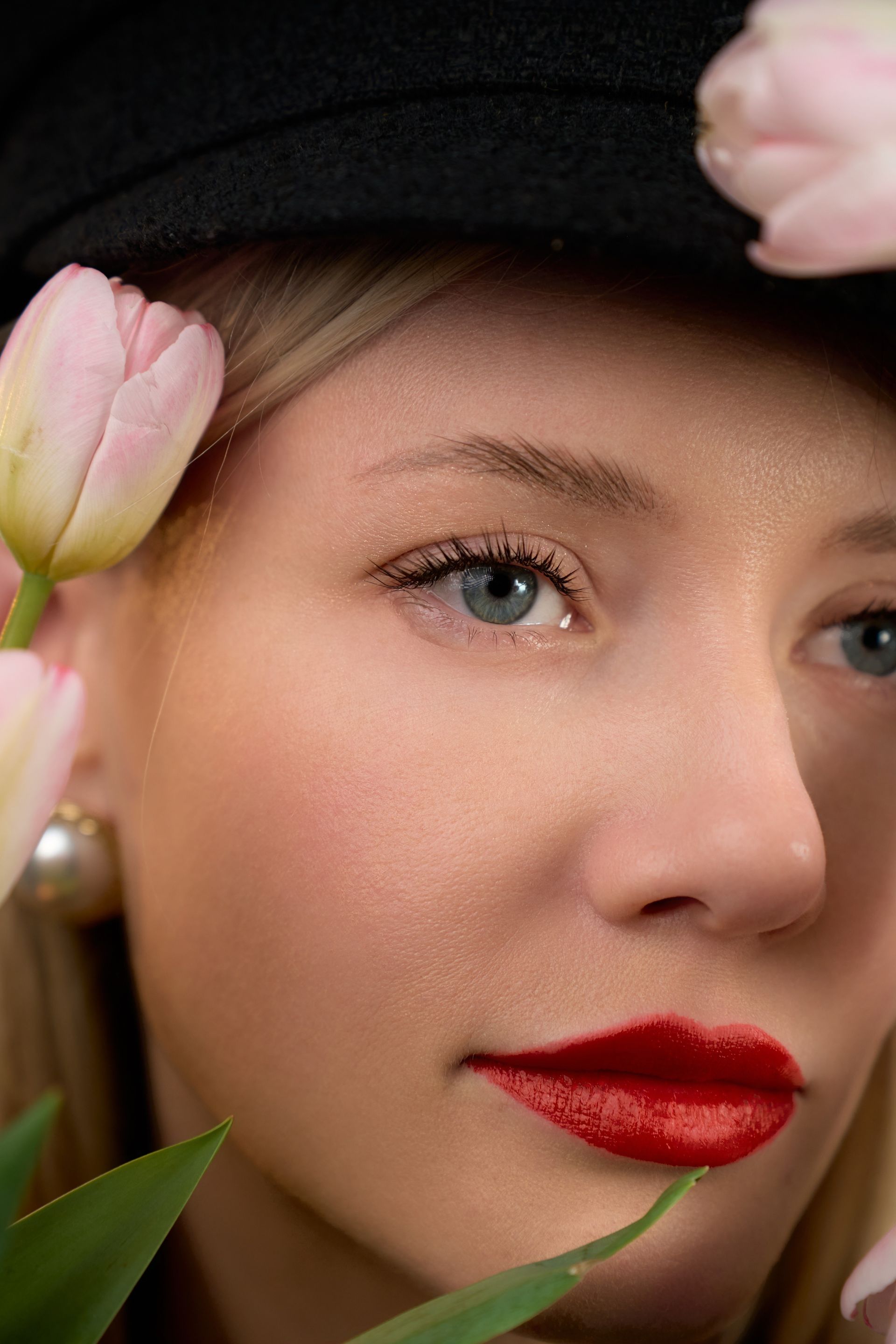 A close up of a woman 's face with flowers in her hair.