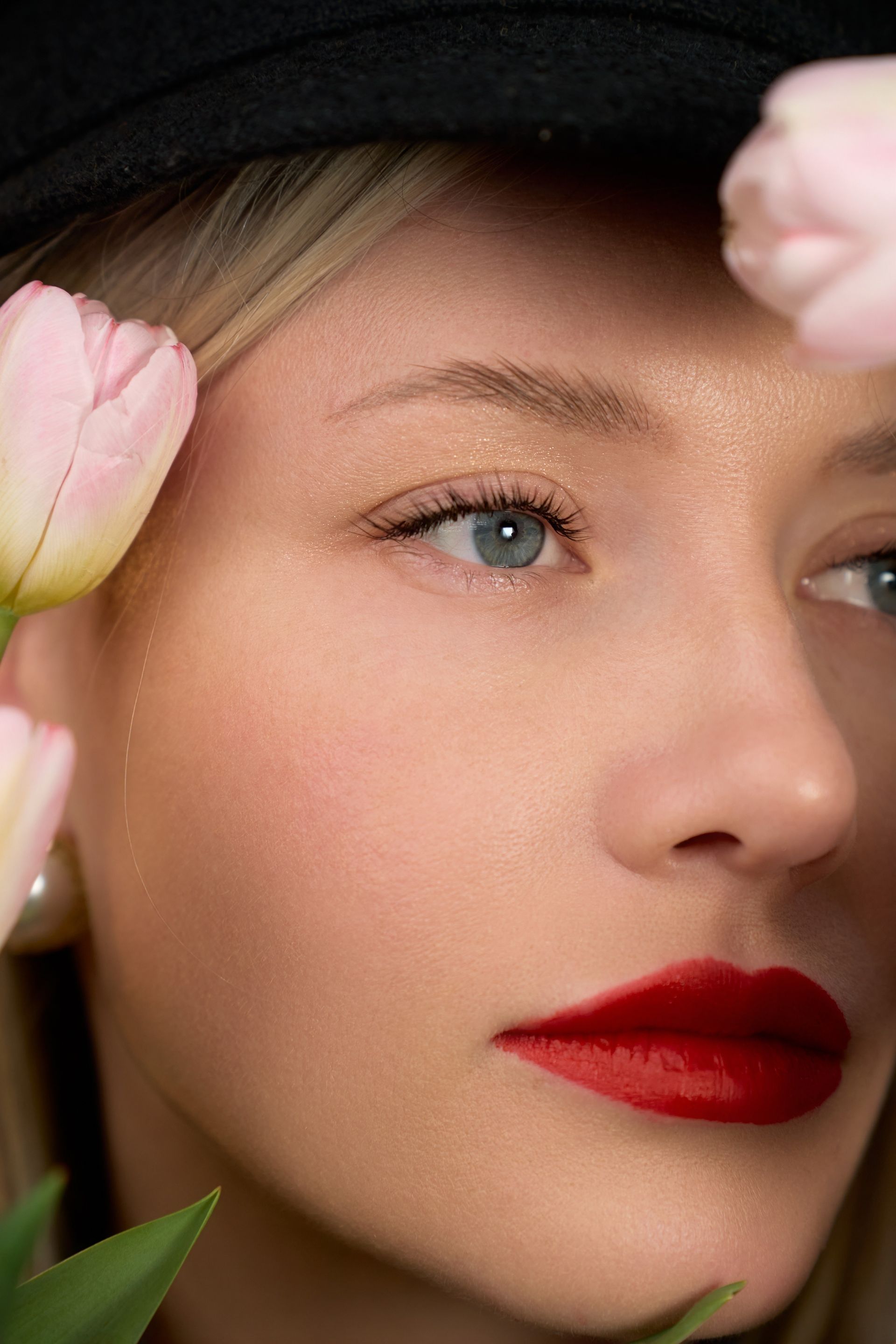 A close up of a woman 's face with flowers in her hair.