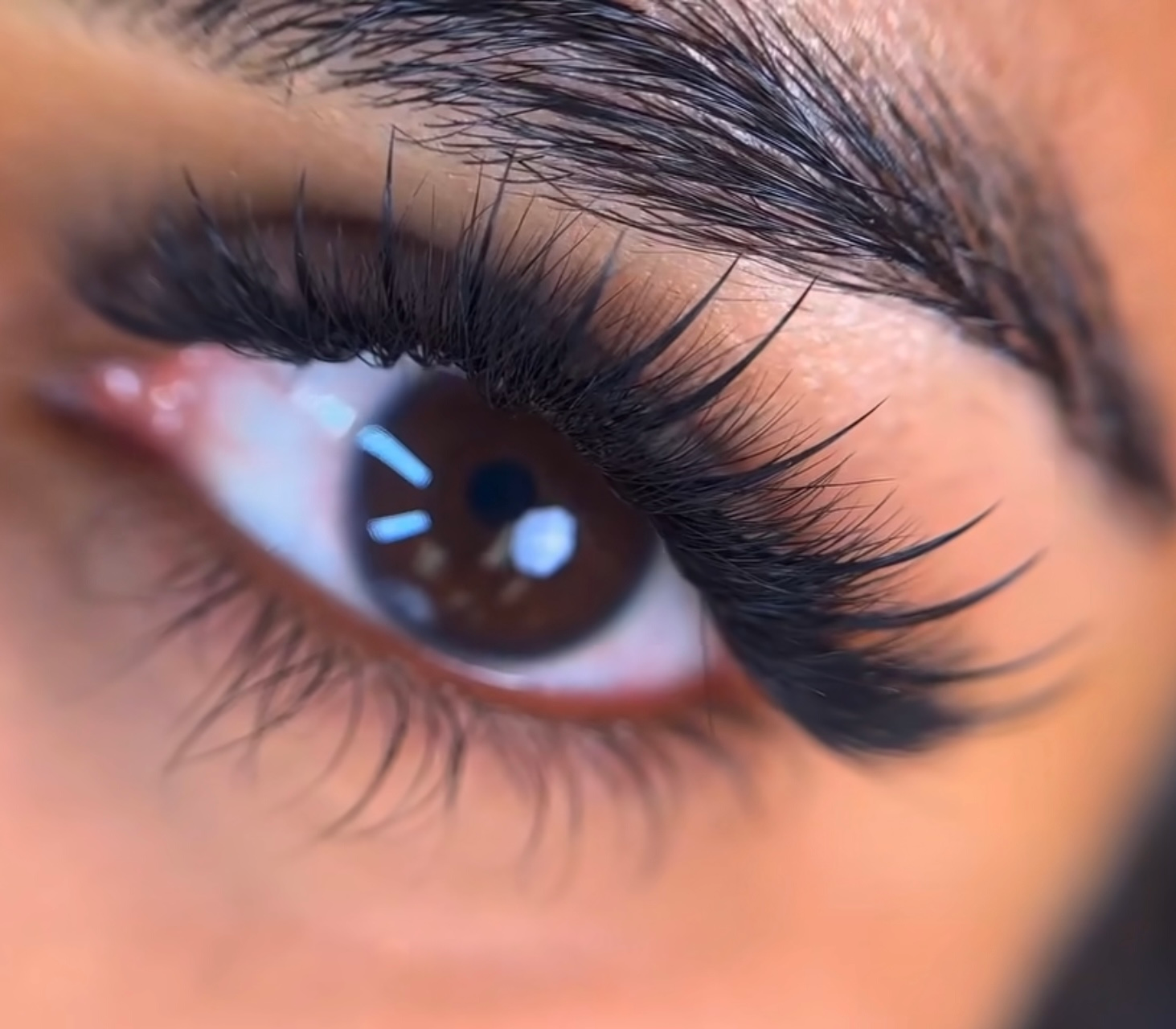A close up of a woman 's eye with long eyelashes