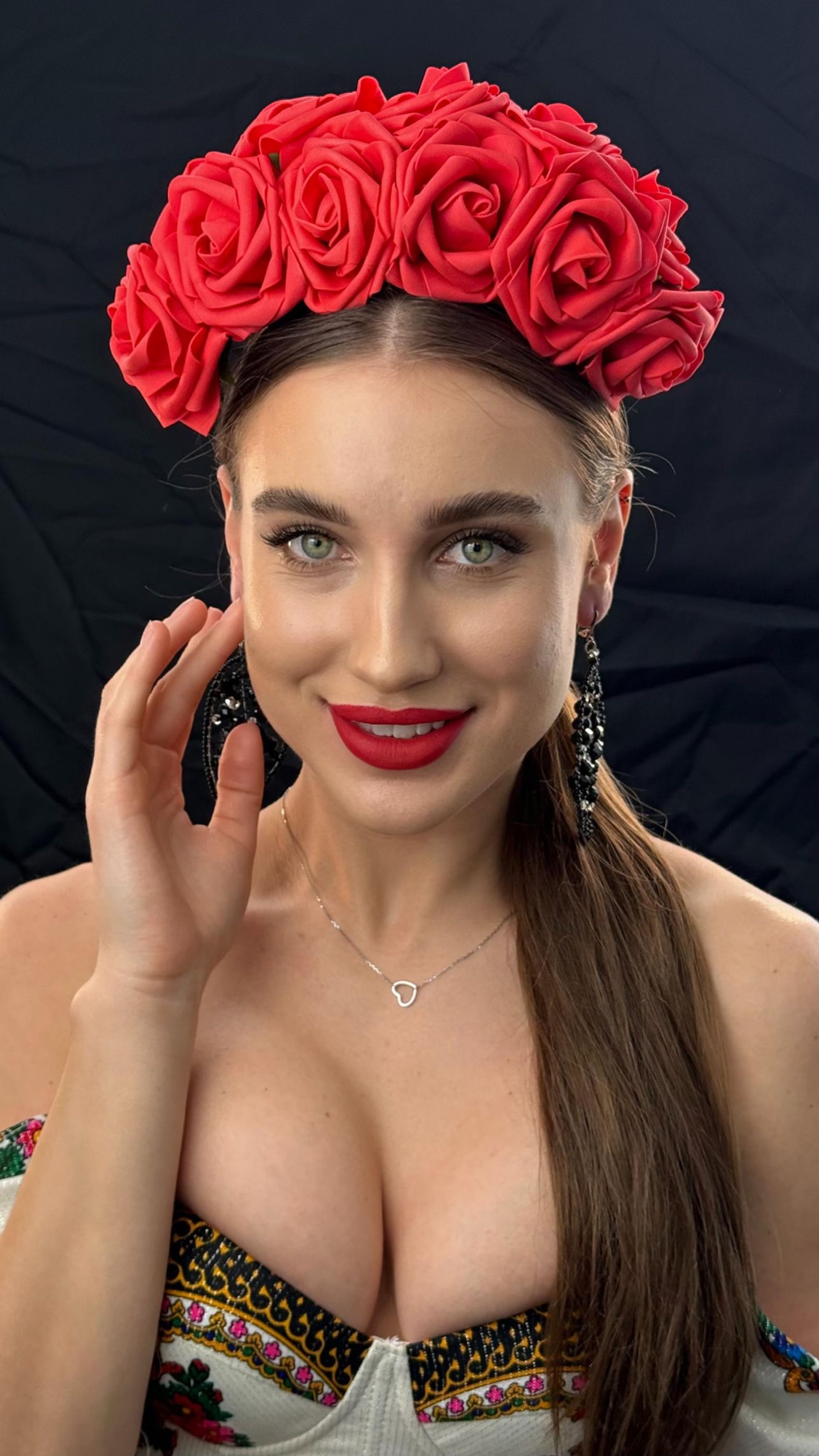 A woman wearing a red headband with red roses on it.