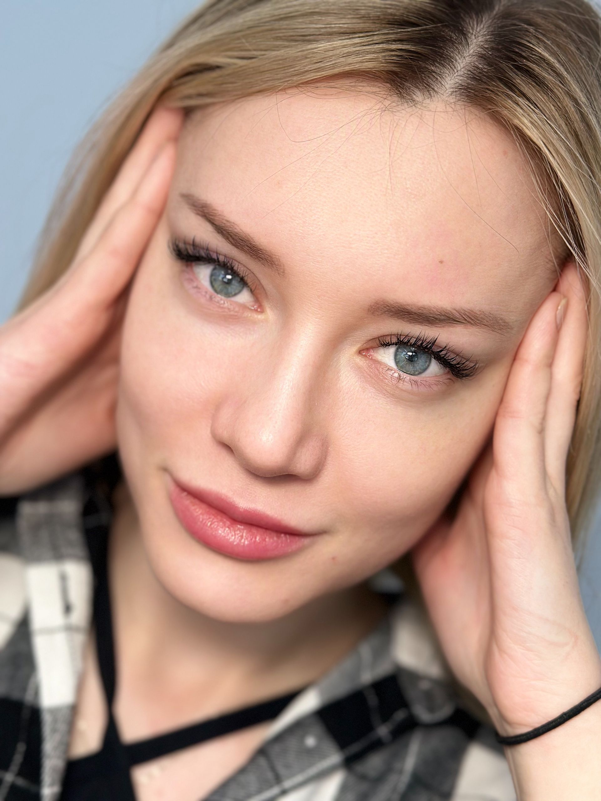 A close up of a woman covering her ears with her hands