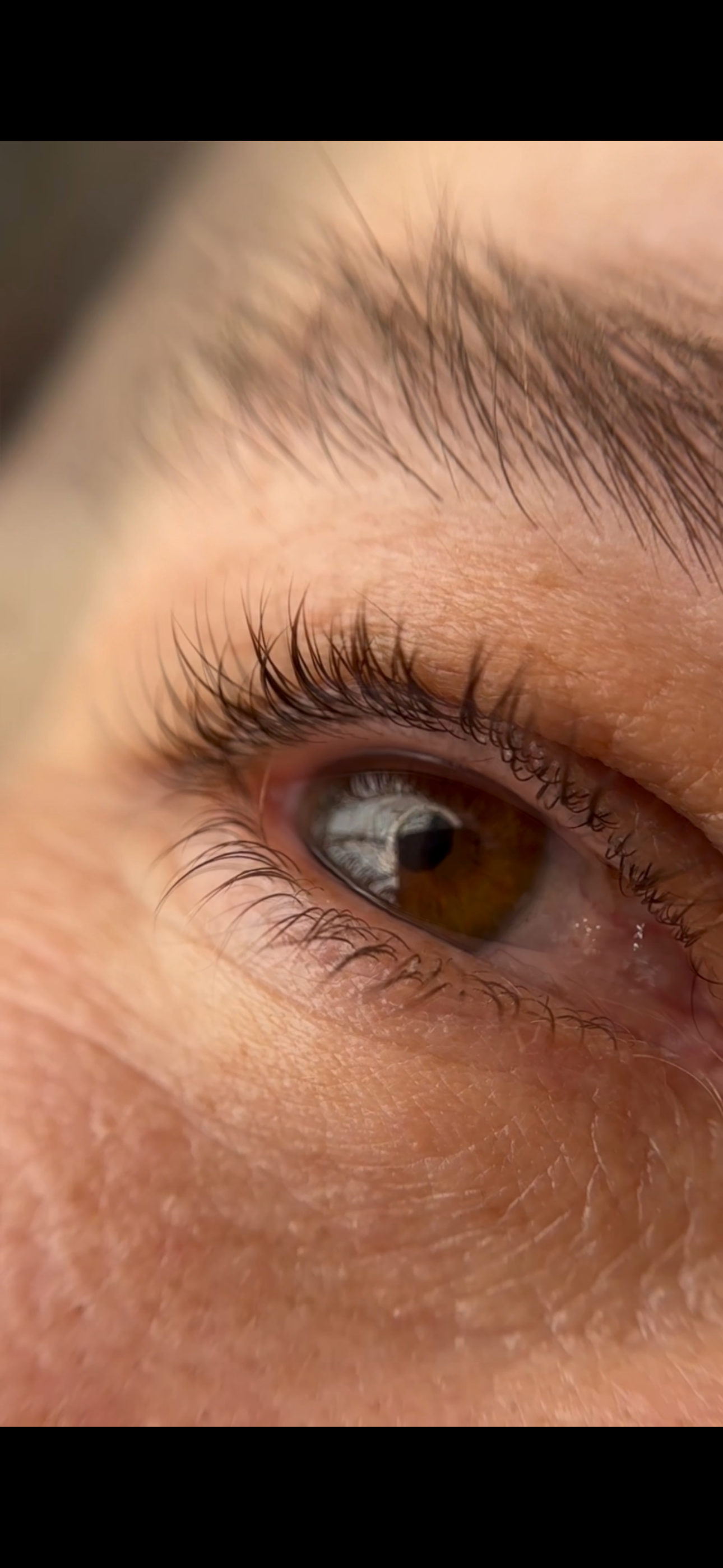 A close up of a person 's eye with mascara on it.