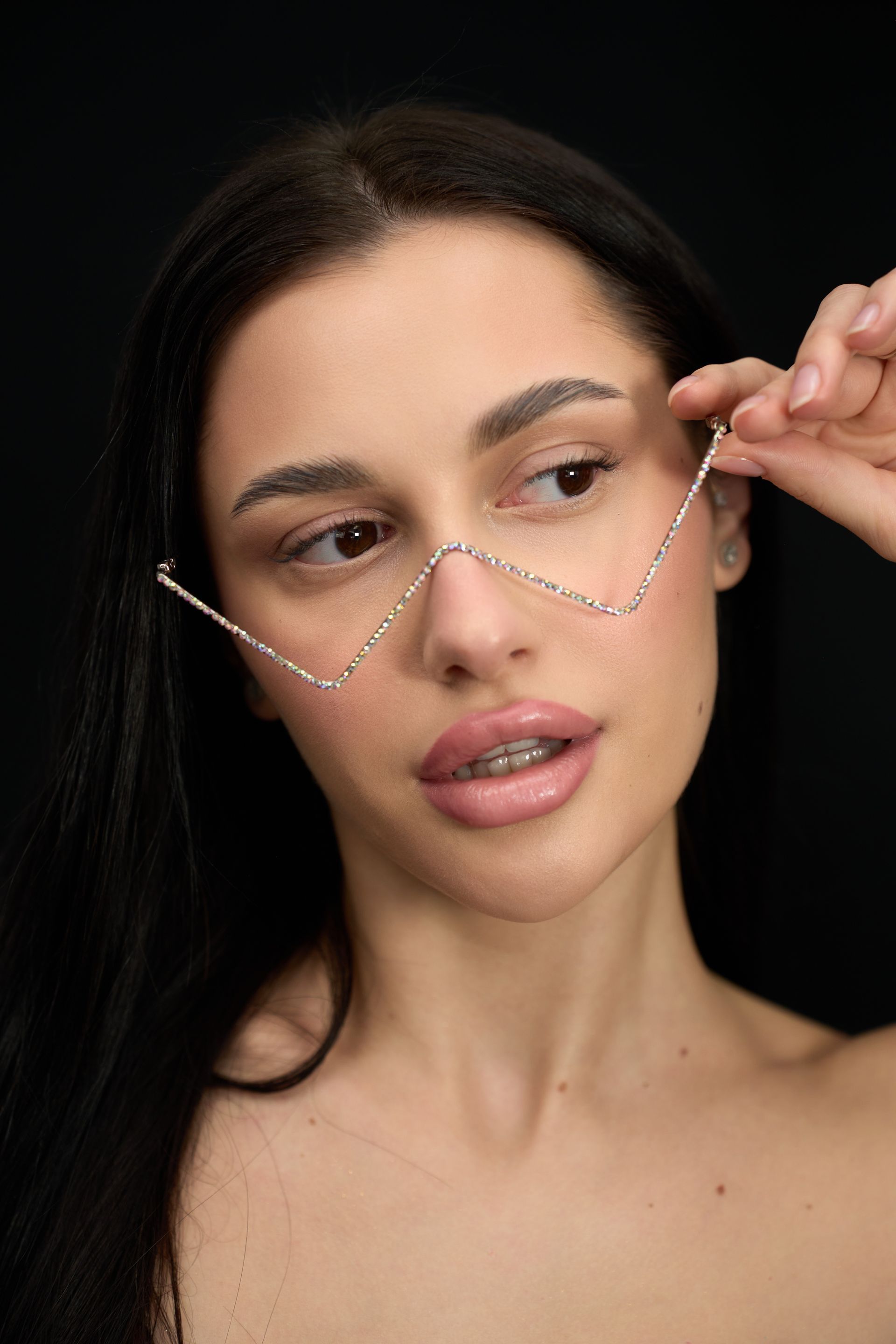 A woman wearing glasses with a chain around her face.