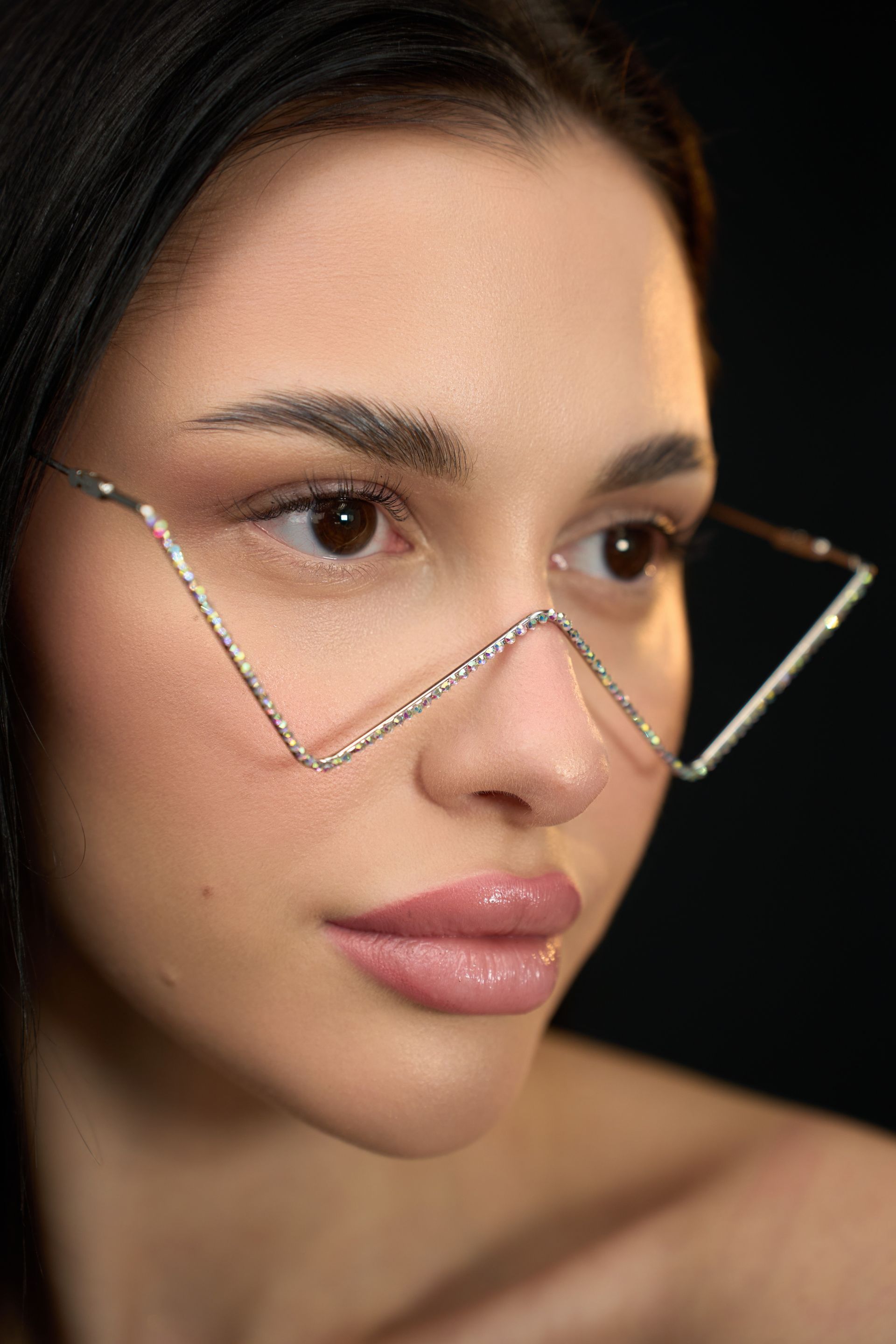 A close up of a woman wearing glasses on her face.