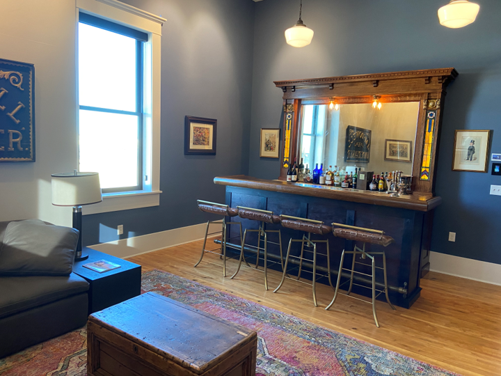 A room with a bar and a couch