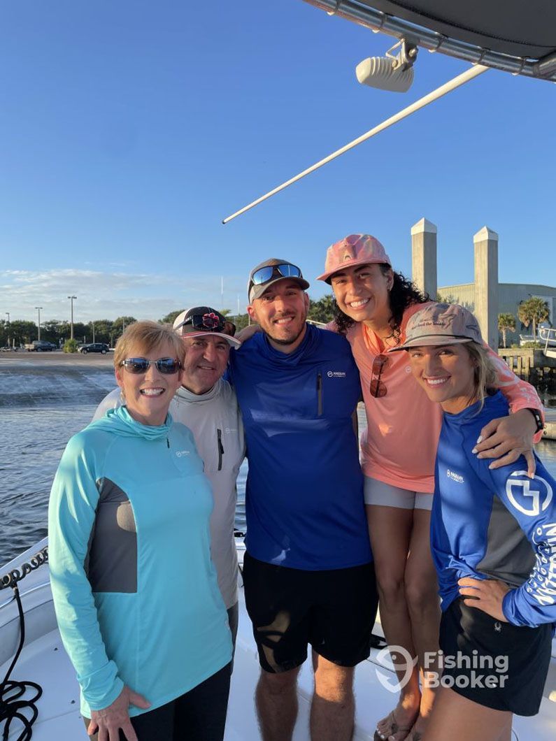 A group of people are posing for a picture on a boat.