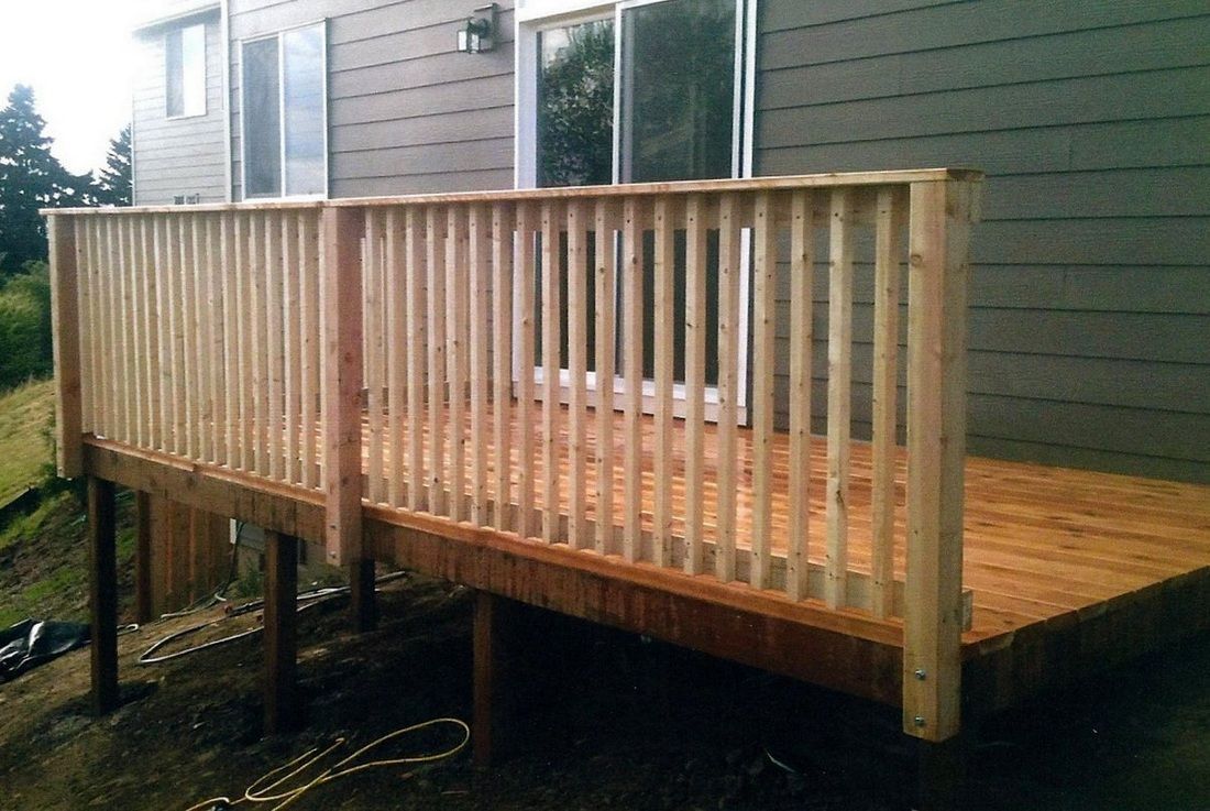 Wooden deck with railing attached to a building's exterior.