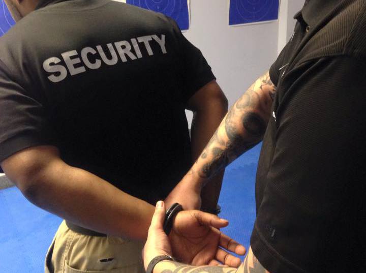 Two Men Demonstrating Handcuff Usage During Security Officer Training