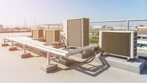 There Are a Lot of Air Conditioners on the Roof of a Building — JHE Air Conditioning Services In Bateau Bay, NSW