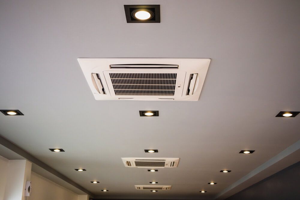 A Row of Ducted Air Conditioners Are Lined Up On The Ceiling — JHE Air Conditioning Services In Saratoga, NSW