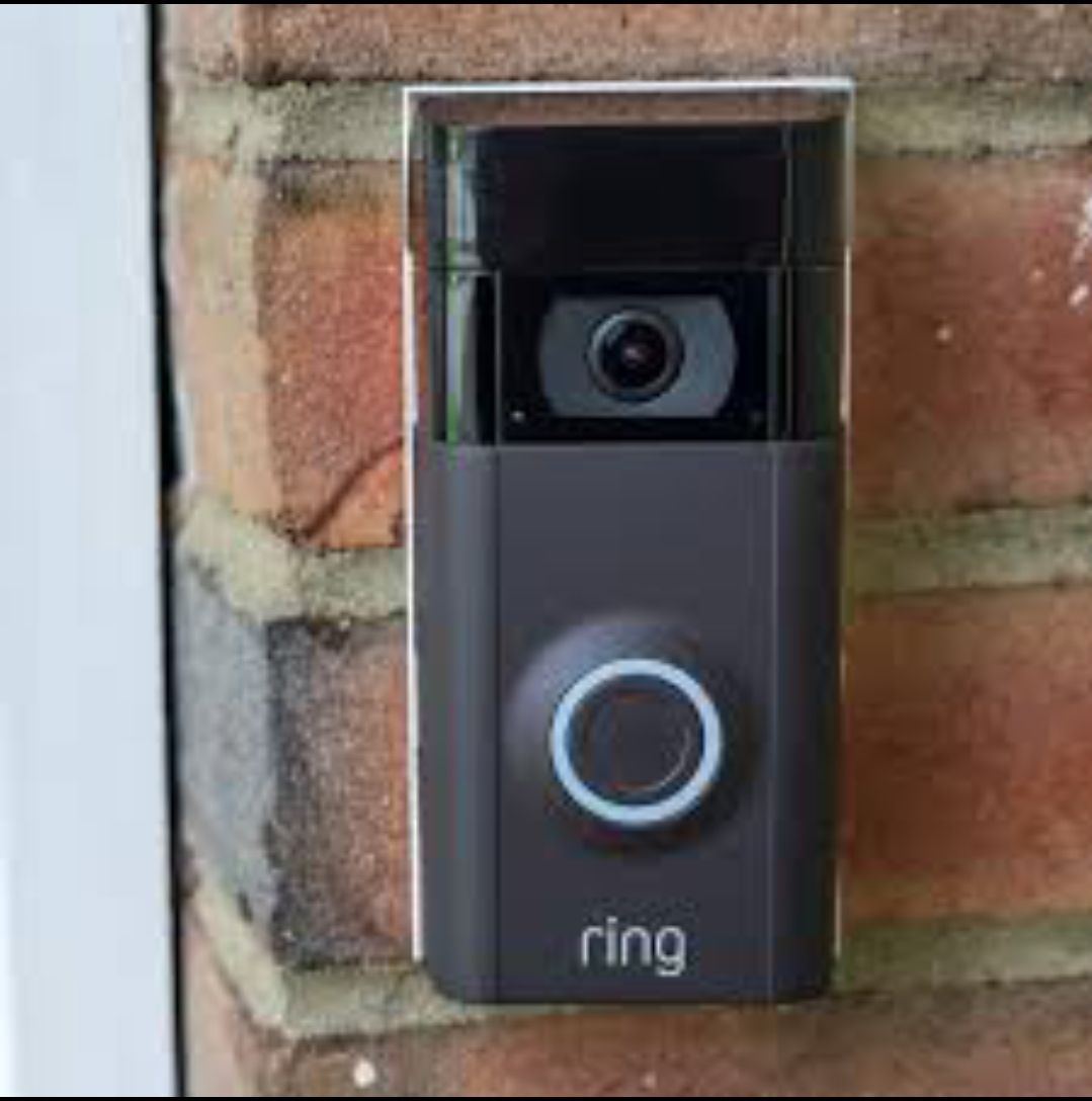 A ring doorbell is mounted on a brick wall.